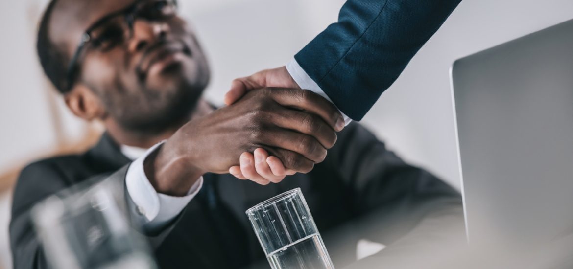 stock-photo-african-american-businessmen-shaking-hand-695652598-transformed